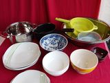 a red table with many dishes and bowls on it