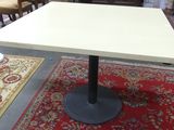 a table that is sitting on a rug in a room