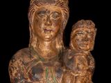 an old statue of a woman holding a child in her arms