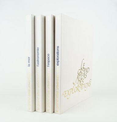 three books are stacked on top of each other on a white surface