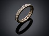 a close up of a wedding ring on a black surface