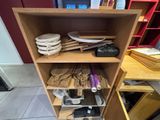 a wooden shelf that has many different items on it