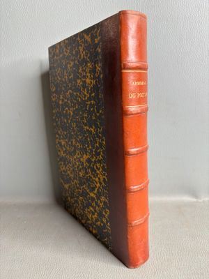 an old book sitting on top of a table next to a white wall