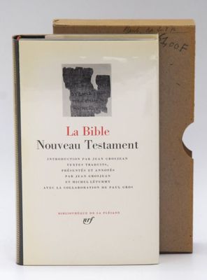 the book is open and sitting on a table next to a cardboard box