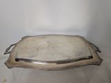 a silver tray with a handle on top of it