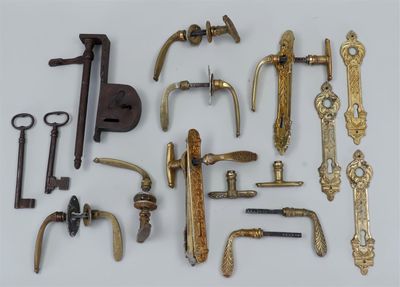many different types of brass hardware on a white surface
