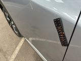 a sticker on the door of a car with a ruler attached to it