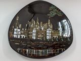 a decorative plate with a picture of a city on it