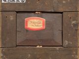an old wooden box with a label on it