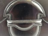 a close up of a silver purse with a metal handle