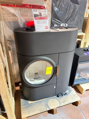 a small stove sitting on a pallet in the middle of a room