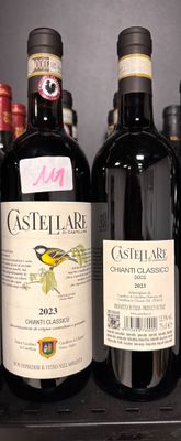 several bottles of wine are lined up on a shelf in a store