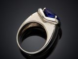 a close up of a ring with a blue stone in it