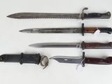 several different types of knives are lined up on a white surface