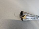 a small metal object on a white surface