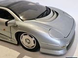 a silver toy car that is sitting on a table