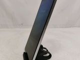 a tablet computer sitting on top of a stand on a white surface