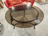 an image of a living room with a red chair and a glass table