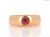 an image of a gold ring with a ruby stone