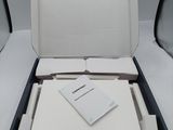 an open box of a white laptop computer sitting on top of a white table