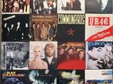 the wall is covered with various album covers of various music