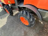 a tractor that is parked on the side of the road