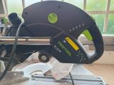 a picture of a green and black circular saw