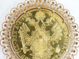 a close up of a gold coin with a crown on it