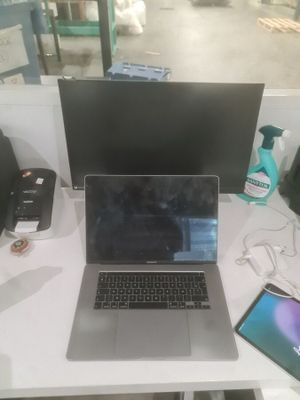 a laptop computer sitting on top of a white desk