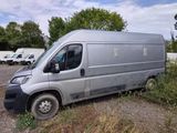 a silver van that is parked in the grass