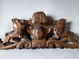 a wood carving of a woman and two dogs