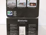 two boxes of electronic appliances sitting on top of a white table