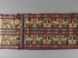 two pieces of cloth with designs on them on a gray surface