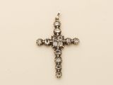 an image of a diamond cross pendant on a white background