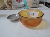 a yellow bowl sitting on a table with a number on it