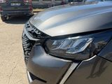 the front end of a gray toyota rav parked in front of a building