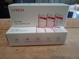 three white boxes with red logos on them sitting on a wooden table