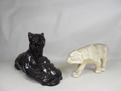 pair of black and white ceramic figurines of a polar bear and a black and white ceramic sculpture of a polar bear