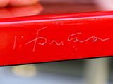 a close up of a red bench with writing on it