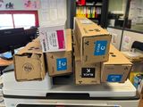 many boxes stacked on top of each other on top of a printer