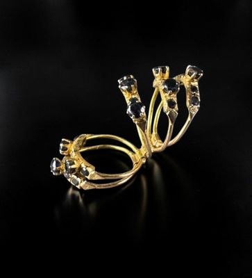 a close up of a gold ring on a black surface