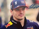signed photo of a red bull driver in a blue cap