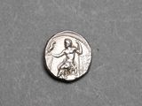 a close up of a silver coin with a woman holding a tennis racquet