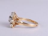 an image of a gold and diamond ring on a white surface