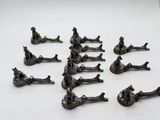 a lot of figurines of people sitting on the ground
