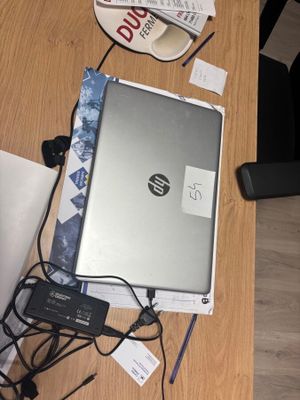 a laptop computer sitting on top of a wooden table