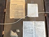 a picture of an old book on display in a frame