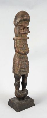 statue of a man standing on a base with a hat on his head
