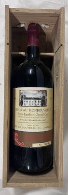 a bottle of wine in a wooden box on a table