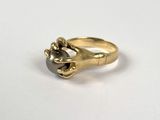 an image of a gold ring with a black stone in the middle